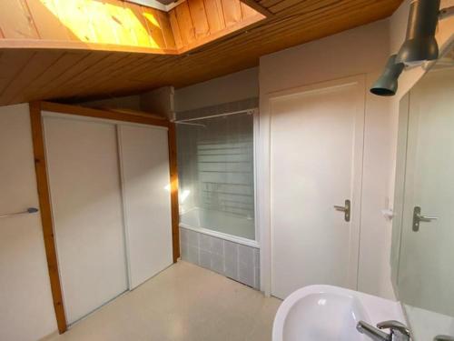 a bathroom with a sink and a glass shower door at Villa Capbreton, 4 pièces, 6 personnes - FR-1-413-114 in Capbreton