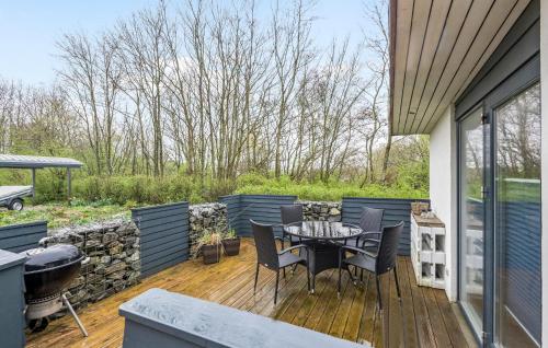 a patio with a table and chairs and a grill at 2 Bedroom Beautiful Home In Esbjerg V in Esbjerg
