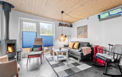 a living room with a couch and a fireplace at 2 Bedroom Beautiful Home In Esbjerg V in Esbjerg