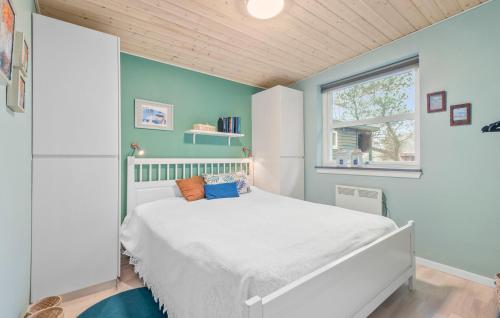 a bedroom with a white bed and a window at 2 Bedroom Beautiful Home In Esbjerg V in Esbjerg