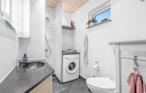 a bathroom with a sink and a washing machine at 2 Bedroom Beautiful Home In Esbjerg V in Esbjerg