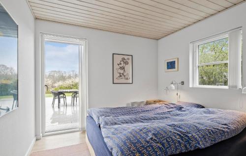 a bedroom with a bed and a large window at Stunning Home In Haderslev With House Sea View in Haderslev