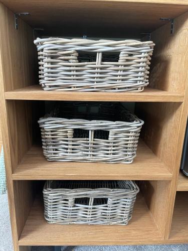 two baskets on a shelf in a cabinet at Cotswold Retreat - Private & Peaceful in Horley