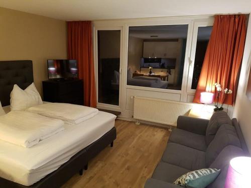 sala de estar con cama y sofá en Wald Apartments im Predigtstuhl Resort en Sankt Englmar