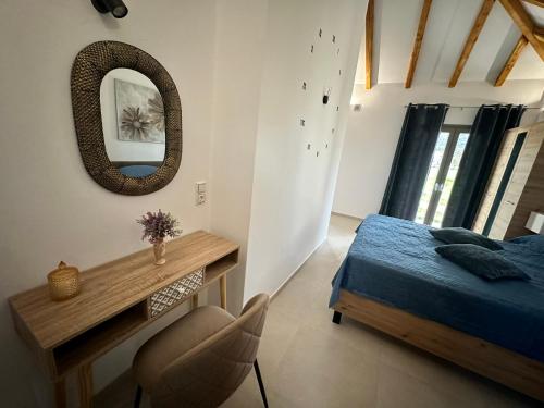 a bedroom with a bed and a mirror and a desk at Ktimavita Apartment 1 in Petra