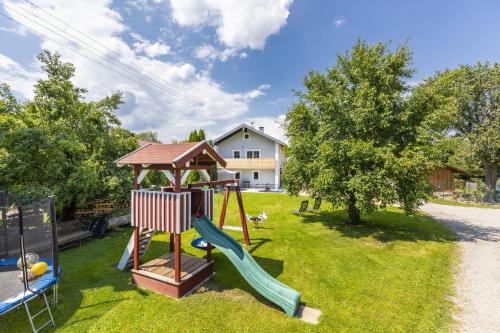 a playground with a slide and a gazebo at Ferienhaus Waldherr in Waging am See