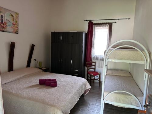 a bedroom with two beds and a bunk bed at SA DOA in Baratili San Pietro