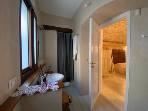 a bathroom with a sink and a toilet in a room at Le Badesse Mitrate by il pumo di puglia in Conversano