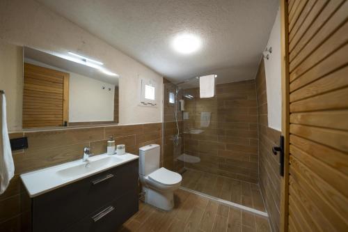 a bathroom with a toilet and a sink and a mirror at Bir Dem Urla in Urla