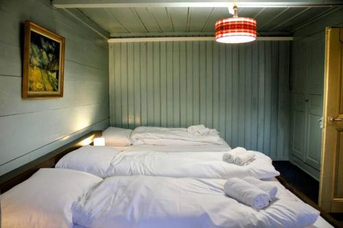 a room with three beds with towels on them at Family-friendly chalet apt with balcony in Meiringen
