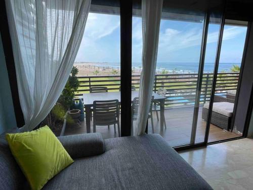 a bedroom with a bed and a view of the ocean at 360 ocean view 2-bedroom lovely apartment in Tamaris
