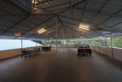 a large room with tables and chairs in it at VILLA MANTRAA in Varkala