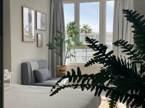 a bedroom with a bed and a large window at APTO Exelsior, Yumbo, Dunas y Playa in San Bartolomé de Tirajana