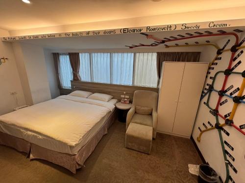 a hotel room with a bed and a chair at RF Hotel – Linsen in Taipei