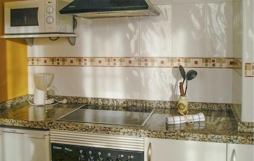 a kitchen with a sink and a counter top at 2 Bedroom Amazing Apartment In Villaviciosa in Villaviciosa
