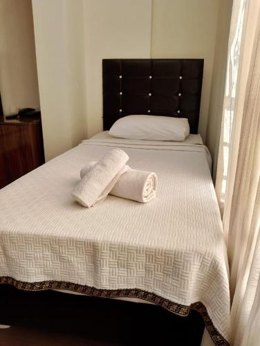 a bed with two towels on top of it at BALŞEN HOTEL in Anamur