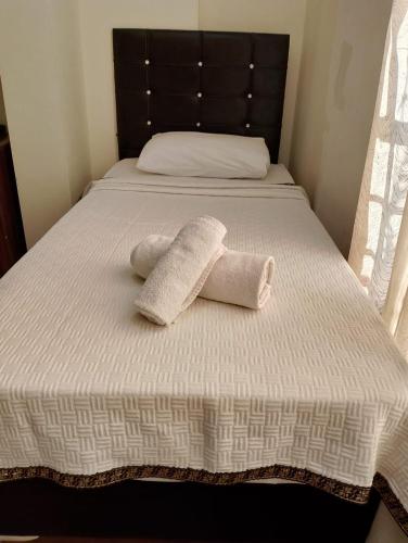 a bed with two towels sitting on top of it at BALŞEN HOTEL in Anamur