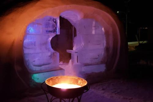 an igloo with a candle in front of it at Loft La Coquille de Lune in Sainte-Rose-du-Nord