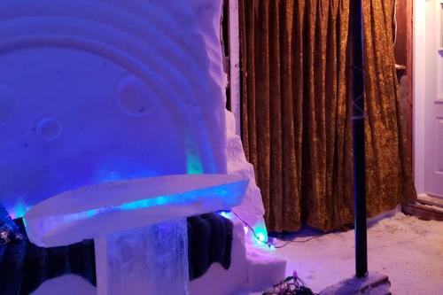 a snow igloo with lights on a table at Loft La Coquille de Lune in Sainte-Rose-du-Nord