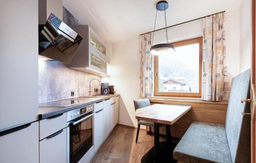 a small kitchen with a table and a window at 1 Bedroom Awesome Apartment In St, Anton in Sankt Anton am Arlberg