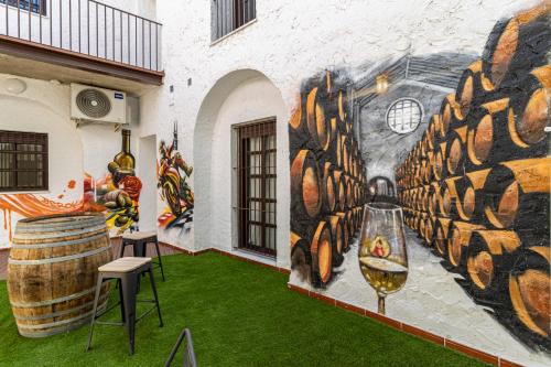 a mural on the side of a building with green grass at Allo Apartments Arroyo Catedral in Jerez de la Frontera