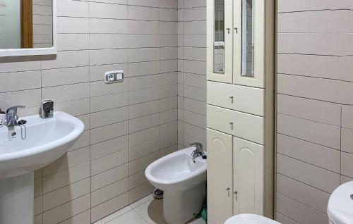 a bathroom with a toilet and a sink at Gorgeous Apartment In San Juan De La Arena With Wifi in San Juan de la Arena