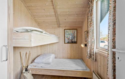 a small bed in a tiny house with a window at Awesome Home In Svendborg With Kitchen in Svendborg