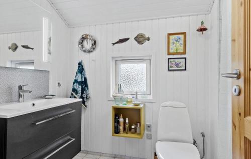y baño con lavabo, aseo y silla. en 2 Bedroom Stunning Home In Havndal, en Havndal