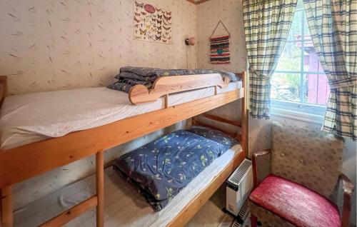 two bunk beds in a room with a window at Gorgeous Home In Sekken With House Sea View in Molde