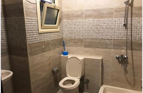 a bathroom with a toilet and a sink and a shower at LASIRENA PALM BEACH RESORT -FAMILY in Ain Sokhna