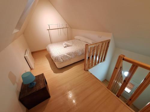 a small bedroom with a bed and a staircase at BUENAVISTA LUXURY in Sierra Nevada