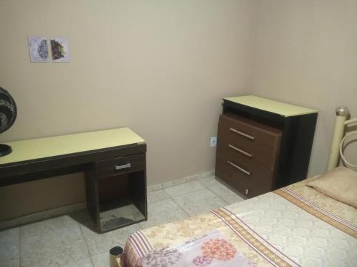 a bedroom with a desk and a bed and a desk and a desk at Residencial Barbosa - Apto 302 in Macaé