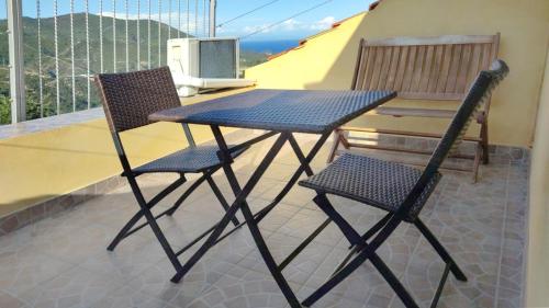 two chairs and a table on a balcony at La vita è bella - Noli in Noli