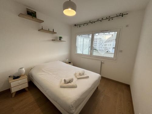 een slaapkamer met een bed met handdoeken erop bij View Point Imperial lake in Annecy
