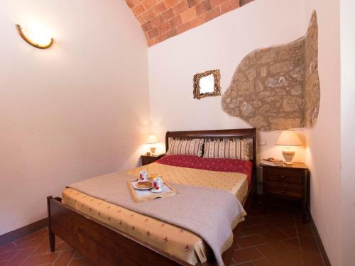 a bedroom with a bed with a tray of food on it at Country House il Ciliegio in Roccatederighi