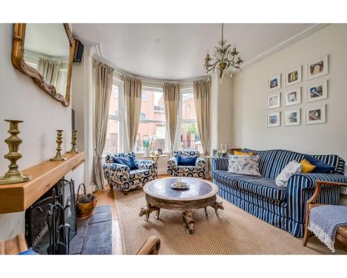 a living room with a couch and a coffee table at Ormeau Park Residence in Belfast