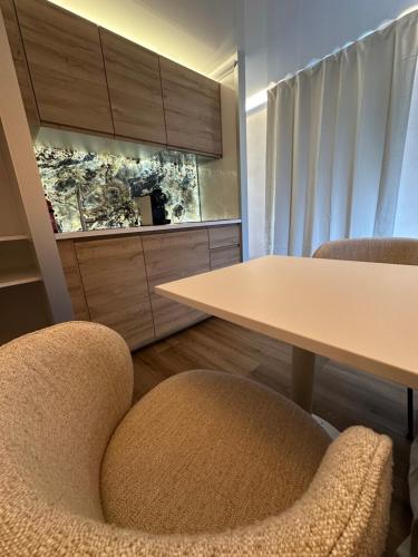 a meeting room with a table and two chairs at L'Escale Royale Saverne - Rhin - Strasbourg in Saverne
