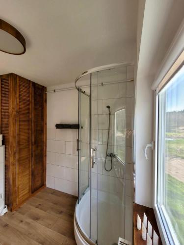 a bathroom with a shower and a bath tub at Petrico Camp Resort in Krzywopłoty