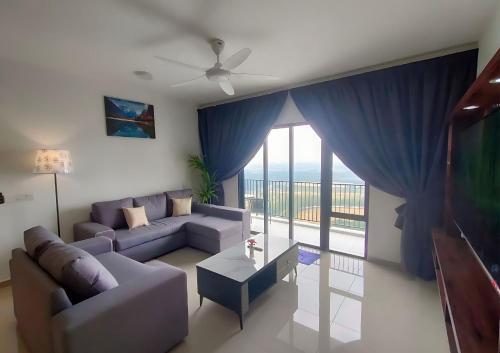 a living room with a couch and a large window at Cozy 3R2B Relax Stay with Amaze Landscape #SR1 in Teluk Panglima Garang
