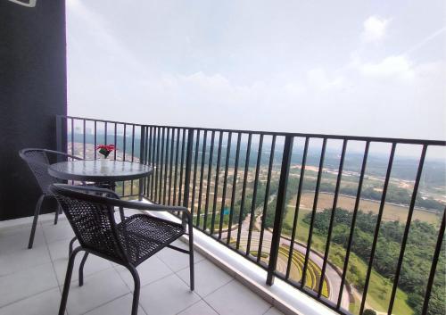 a table and chair on a balcony with a view at Cozy 3R2B Relax Stay with Amaze Landscape #SR1 in Teluk Panglima Garang