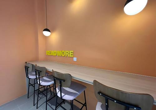 a bar with chairs and a sign that reads need more at Cozy 3R2B Relax Stay with Amaze Landscape #SR1 in Teluk Panglima Garang
