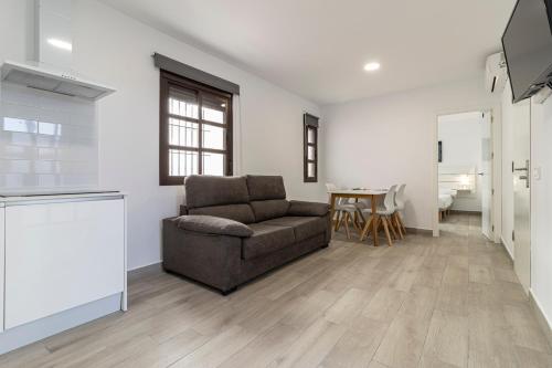 a living room with a couch and a table at Allo Apartments Arroyo Catedral in Jerez de la Frontera