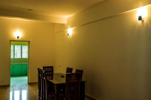 a dining room with a table and chairs at ADONAY INN RESIDENCY in Kalpetta