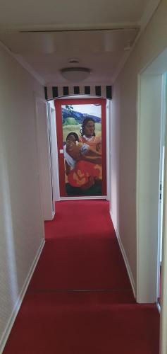 a hallway with a red carpet and a painting on the wall at Alte-post in Wissen