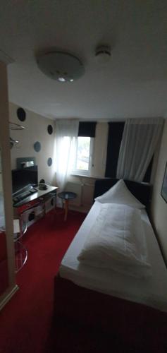 a bedroom with a white bed and a desk at Alte-post in Wissen