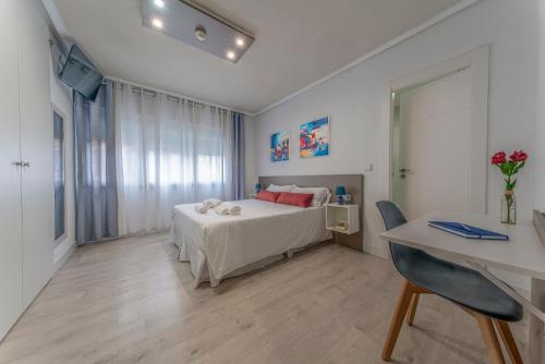 a bedroom with a bed and a desk and a desk at Hotel Gabriel y Galán in Salamanca