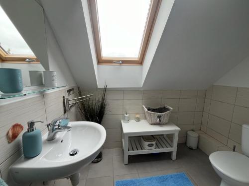 a bathroom with a sink and a toilet at Domek wakacyjny MĄTWA - 150 metrów od plaży! in Karwieńskie Błoto Pierwsze