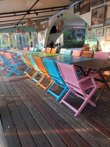 a group of colorful chairs sitting around a table at Relaks w Marina Cape 88 in Aheloy