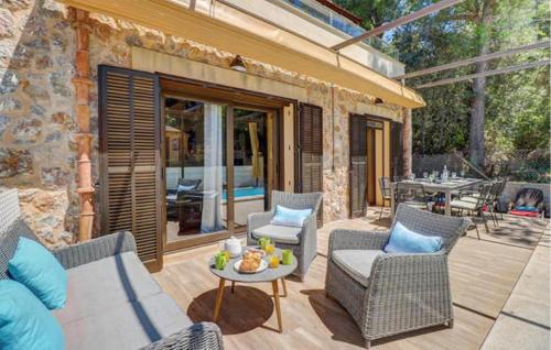 a patio with two chairs and a table with a table at 4 Bedroom Cozy Home In Mal Pas, Bonaire in Cielo de Bonaire 