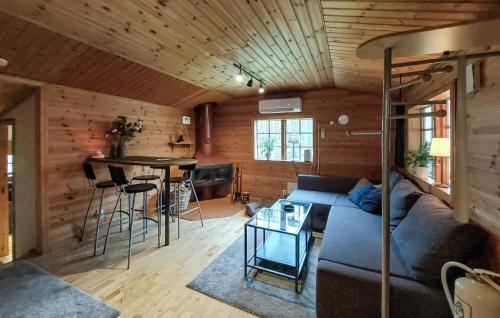 a living room with a couch and a table at 2 Bedroom Awesome Home In Ljungby in Ljungby